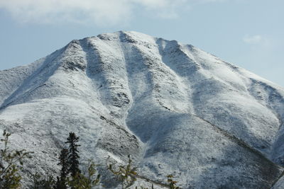 Low angle view of snowcapped mountain against sky