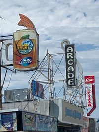 Low angle view of road sign against sky