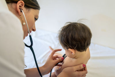 Doctor passing a baby girl's check-up at the hospital