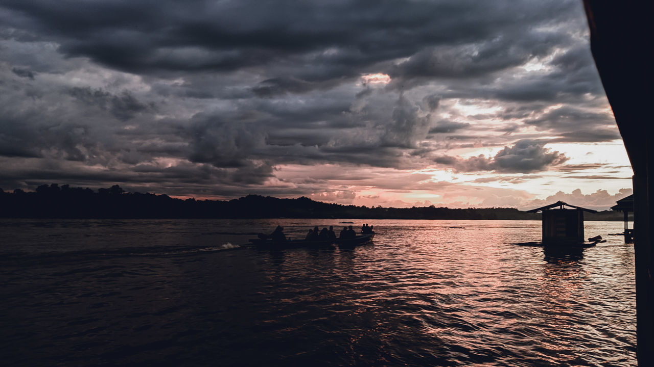 cloud, water, sky, sea, beauty in nature, nature, reflection, sunset, dramatic sky, scenics - nature, dusk, horizon, evening, tranquility, no people, ocean, environment, cloudscape, beach, storm, outdoors, nautical vessel, tranquil scene, land, architecture, darkness, storm cloud, travel destinations, sunlight, seascape, transportation, landscape