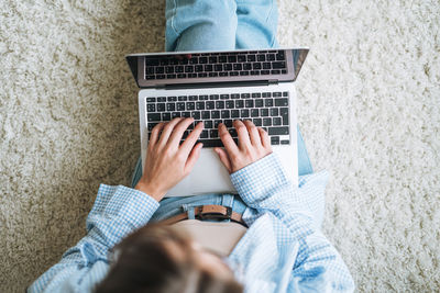 Low section of woman using laptop