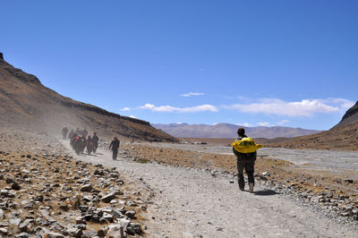 Low angle view of people on mountain