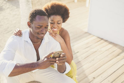 Young couple holding smart phone 