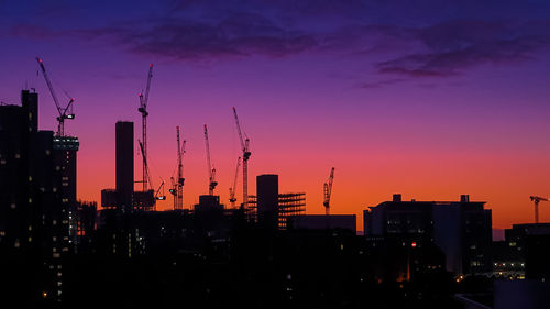 Silhouette buildings against sky during sunset