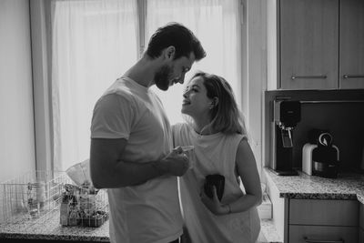 Rear view of couple standing at home