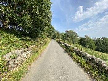 Looking along, hey's lane, with dry stone walls, fields, and old trees in, wainstalls, halifax, uk