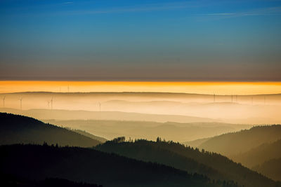 Scenic view of silhouette mountains against sky at sunset