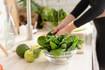 Close-up of spinach in bowl on kitchen counter