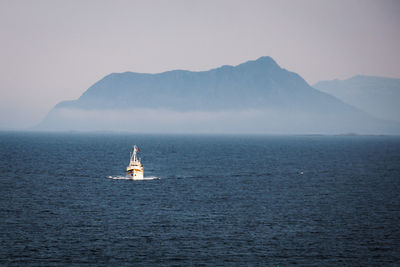 Sailboat sailing on sea against sky