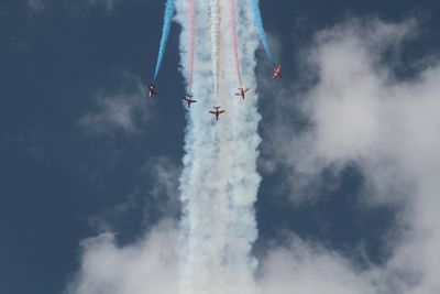 Low angle view of airplane flying against sky