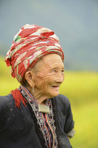 Portrait of a smiling young woman looking away outdoors