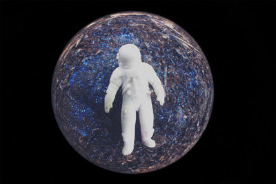 Close-up of figurine against black background