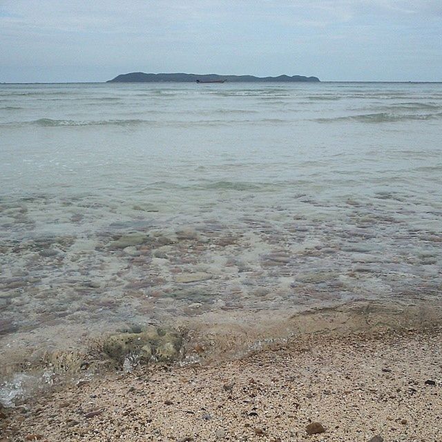 sea, water, beach, horizon over water, shore, tranquil scene, tranquility, scenics, beauty in nature, sand, sky, nature, wave, coastline, idyllic, remote, seascape, calm, day, outdoors