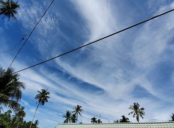 Low angle view of power lines against sky