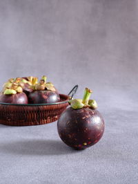 Eye level view of mangosteen fruit on table. 