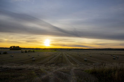 Scenic view of field against sky during sunset