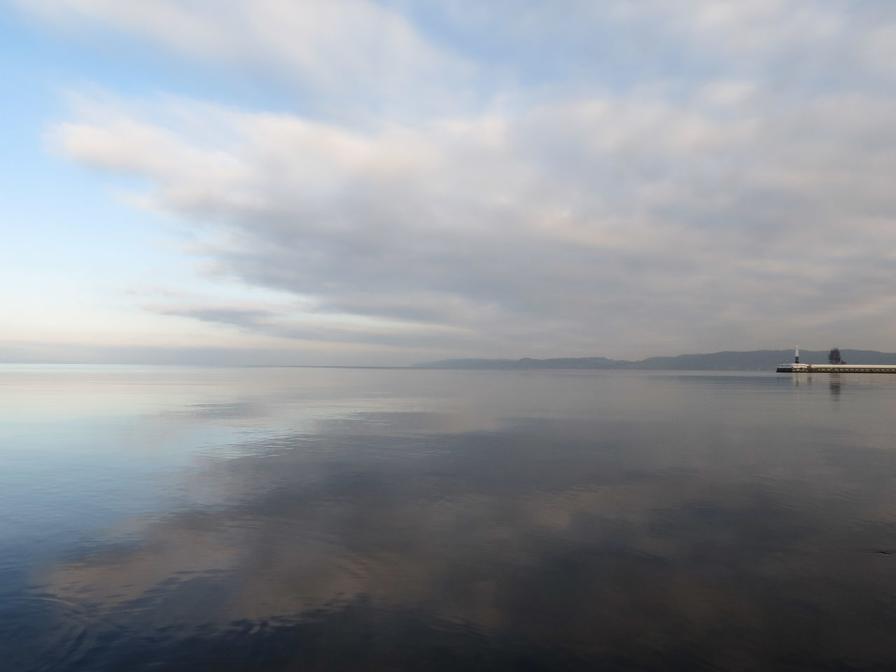 water, sea, sky, tranquil scene, tranquility, scenics, nautical vessel, cloud - sky, beauty in nature, horizon over water, transportation, waterfront, boat, cloudy, nature, mode of transport, reflection, cloud, idyllic, calm