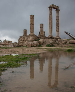 Ruins of building against cloudy sky