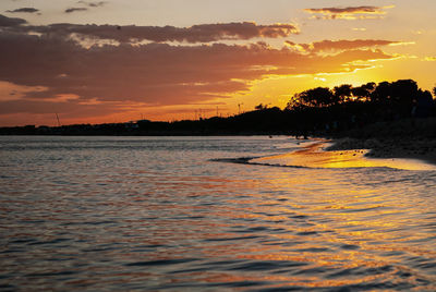 Scenic view of sea against orange sky