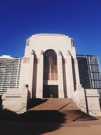 Low angle view of building against blue sky