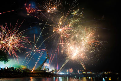 Low angle view of firework display at night