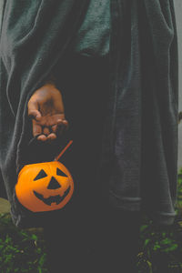 Full length of a man holding pumpkin