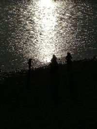 Silhouette men against sky during sunset