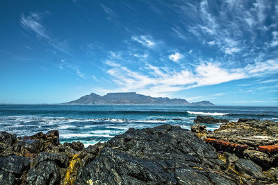 Panoramic seascape view of cape town and table mountain from remote robben island, south africa