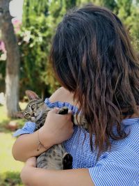 Midsection of woman holding cat