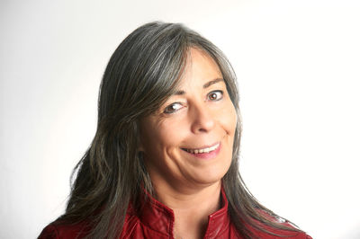 Portrait of young woman against white background