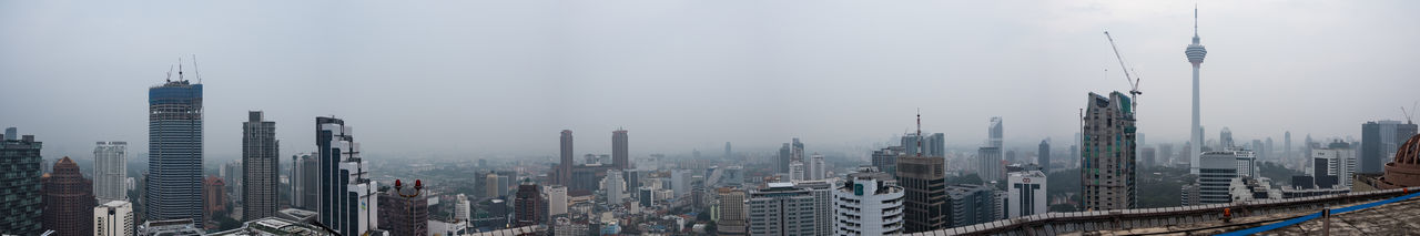 Panoramic view of urban skyline against sky