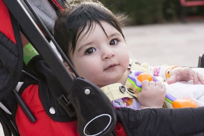 Portrait of cute baby girl with toy