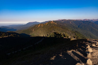 Scenic view of mountains against blue sky