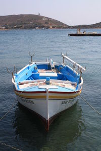 Boat moored in sea against sky