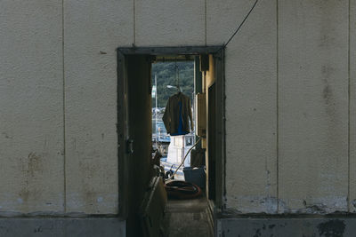 Rear view of man on wall of building