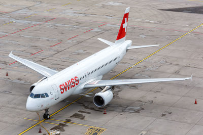 High angle view of airplane on airport runway