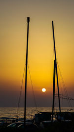 Silhouette sailboats on sea against sky during sunset