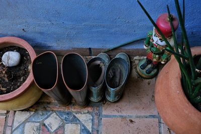 High angle view of shoes on potted plant against wall