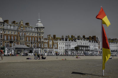 Group of people in front of buildings against sky