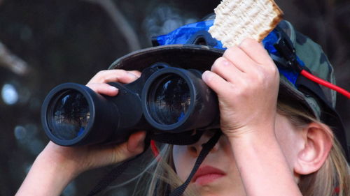 Low angle view of girl holding binoculars