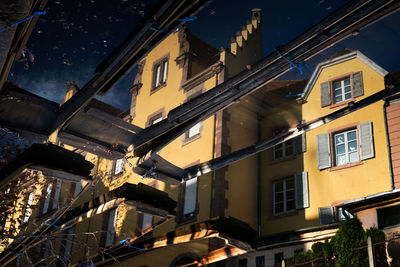 Low angle view of illuminated buildings against sky