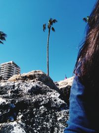 Low angle view of people against clear sky