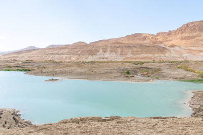 Sinkhole filled with turquoise water, near dead sea coastline a hole formed when underground salt is