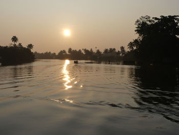 Scenic view of lake against sky during sunset