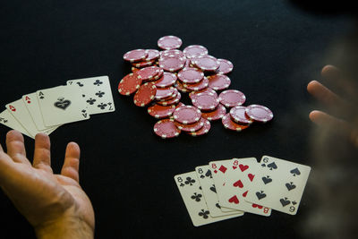 High angle view of man hand playing poker on table