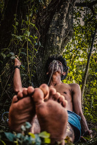 Low angle view of woman standing in forest