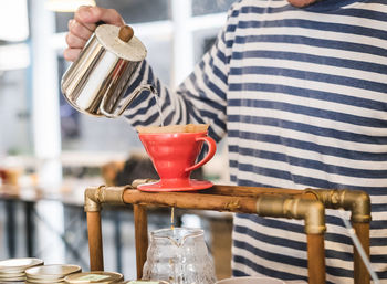 Midsection of man preparing coffee