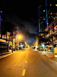 Illuminated city street and buildings at night