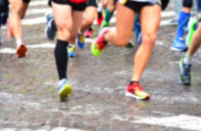 Low section of people running on street