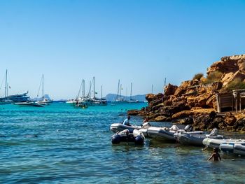 Sailboats moored in marina